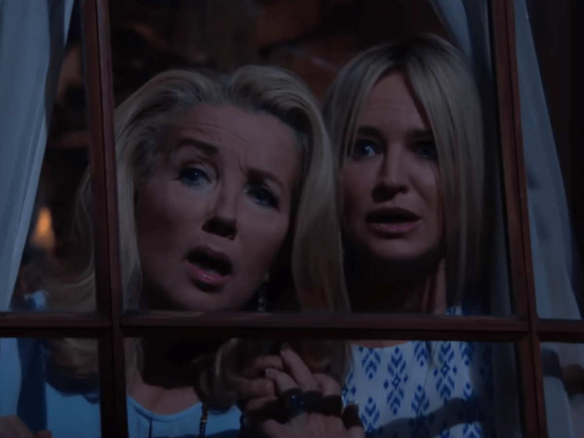 Nikki and Sharon with shocked faces looking out a window